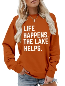 Detail of burnt orange sweatshirt with Life Happens The Lake Helps white letter print