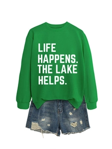 Detail of green sweatshirt with Life Happens The Lake Helps print and denim shorts