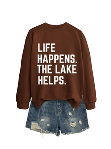 Detail view of brown crewneck sweatshirt with 'LIFE HAPPENS. THE LAKE HELPS.' white text