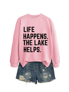 Flat lay detail of pink sweatshirt with Life Happens The Lake Helps text and denim shorts