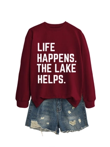 Close-up of Life Happens The Lake print on maroon sweatshirt and ripped denim shorts