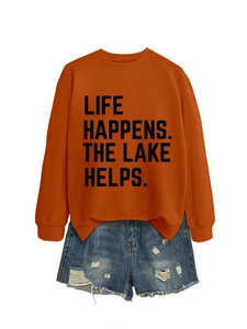 Detailed flat lay of orange crewneck sweatshirt with Life Happens letter print design