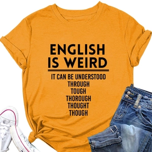 Flat lay of an orange cotton t-shirt with slogan, paired with denim shorts and shoes