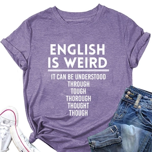 Flat lay of purple cotton T-shirt with white graphic text, denim shorts and sneakers