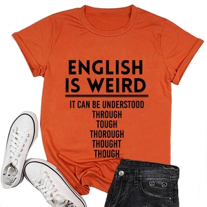 Flat lay of an orange crew neck cotton T-shirt with black slogan and casual denim outfit