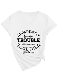 Detail view of white V-neck T-shirt featuring a black slogan print and a stylish front knot