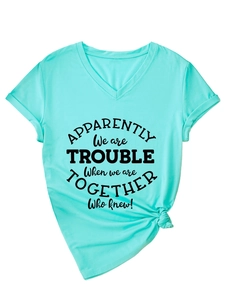 Detail of mint green V-neck T-shirt with quote print, rolled sleeves and knotted hem
