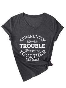 Detail of dark grey V-neck T-shirt with white slogan print and stylish front knot