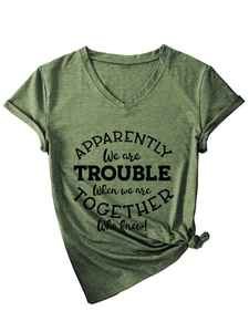 Detail of green V-neck T-shirt featuring a front knot and printed slogan