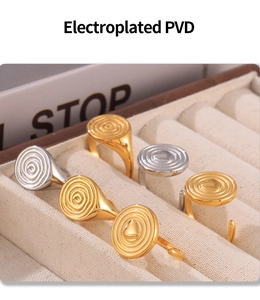Detail of PVD electroplated gold and silver heart rings with spiral hammered texture