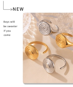Detail of gold and silver hammered spiral rings with adjustable open band design