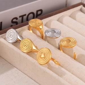 Minimalist hammered gold and silver rings set with heart accents and spiral texture
