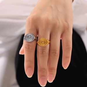 Chic 18k gold and silver hammered vortex rings in a modern minimalist style