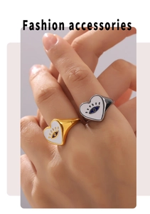 Detailed view of heart-shaped evil eye enamel rings in gold and silver plating