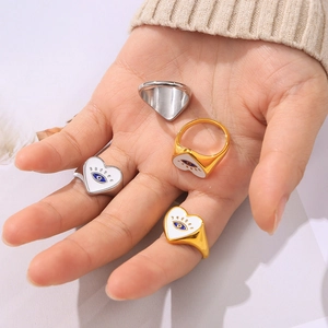 Bohemian heart evil eye rings in gold and silver finish on hand with knit background