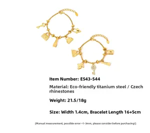 Detailed macro view of 18K gold plated charms including key, heart lock, and bag pendants