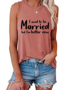 Detail of soft coral tank top featuring black slogan print and high-quality fabric texture
