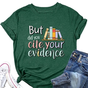 Detail view of dark green t-shirt featuring book graphics and a stylish hem knot