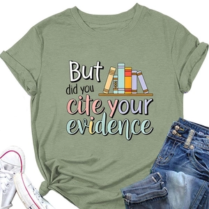 Detailed view of olive green t-shirt with academic quote and book graphics