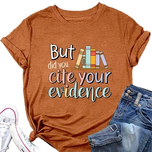 Flat lay of burnt orange T-shirt with book graphics and academic citation slogan