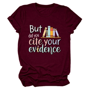 Close-up of burgundy cotton T-shirt featuring colorful books and academic quote print