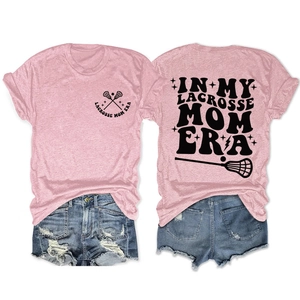 Flat lay detail of pink Lacrosse Mom T-shirt and denim shorts with graphic print