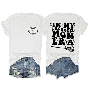Flat lay of Lacrosse Mom graphic white t-shirt and distressed denim shorts summer set