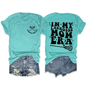 Flat lay detail of In My Lacrosse Mom teal t-shirt front and back with denim shorts