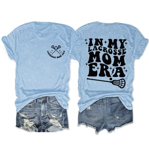 Flat lay of light blue lacrosse mom t-shirt and distressed denim shorts summer outfit