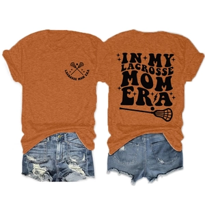 Detail view of orange T-shirt with Lacrosse Mom print and ripped blue denim shorts set