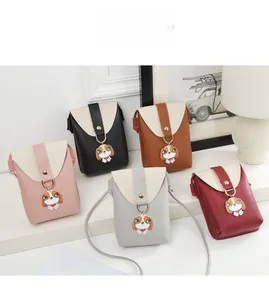 Detailed close-up showing five mini crossbody phone bags in various colors with cute dog charms