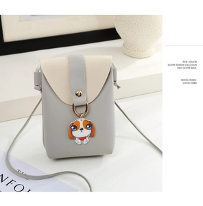Detail of mini crossbody phone bag with cute cartoon puppy pendant and PU leather finish