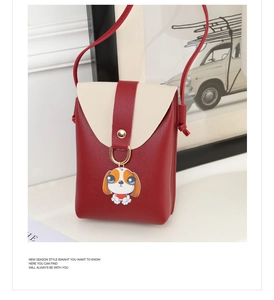 Detail of red and cream crossbody phone bag with cute cartoon dog pendant and ring