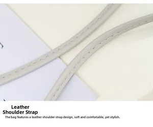 Detail of light grey leather shoulder strap with neat stitching for mini crossbody bag