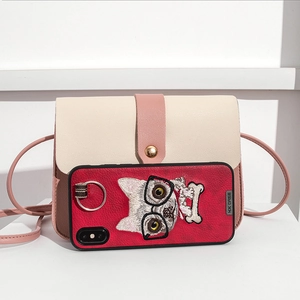 Pink and white crossbody mini bag with litchi grain texture and gold circular buckle