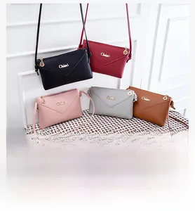 Detailed view of women's envelope crossbody phone bags in five elegant colors with leaf charms