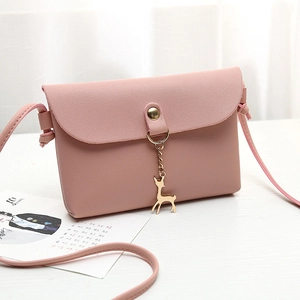 Stylish pink faux leather crossbody bag for women with golden deer charm detail