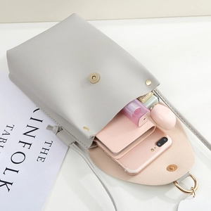 Minimalist light gray PU leather crossbody phone bag shown with daily essentials