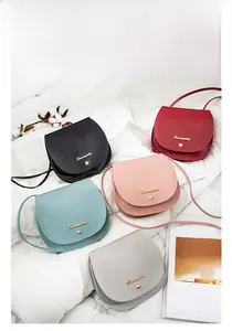 Flat lay of small flap crossbody bags in five colors with lychee pattern leather