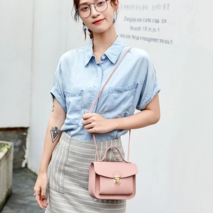 Elegant mini light pink crossbody bag with gold lock buckle and top handle for women