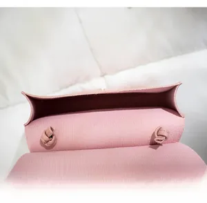 Detail view of pink PU leather saddle bag interior showing drawstring knot and storage space