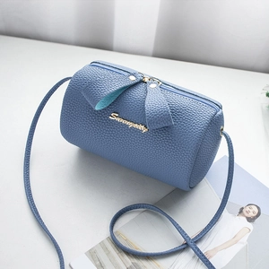 Morandi blue cylinder crossbody bag with lychee grain leather and gold logo details