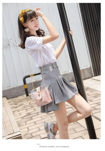 Detail of grey pleated high-waist mini skirt with asymmetrical hem and matching belt