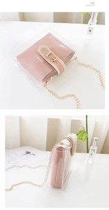 Detail view of transparent PVC chain bag with pink inner pouch and gold hardware