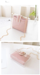 Detail of transparent PVC crossbody bag with pink leather inner pouch and gold chain strap