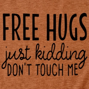 Close-up of fabric texture and black 'Free Hugs' print on a caramel cotton T-shirt