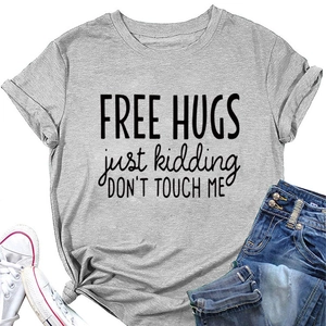 Detailed view of gray cotton t-shirt with Free Hugs slogan and denim jeans flat lay
