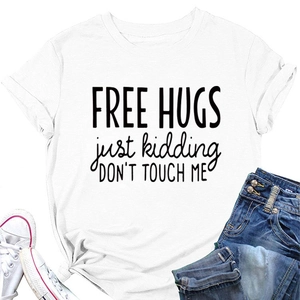 Flat lay of white cotton T-shirt featuring Free Hugs Just Kidding black typography print