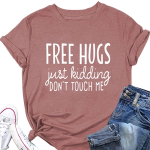 Detail view of cotton t-shirt featuring Free Hugs print with jeans and sneakers