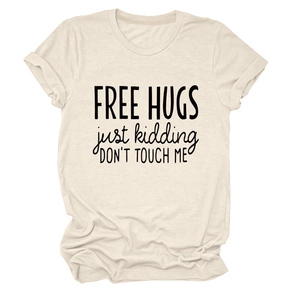 Detail of beige cotton t-shirt featuring Free Hugs Just Kidding printed slogan
